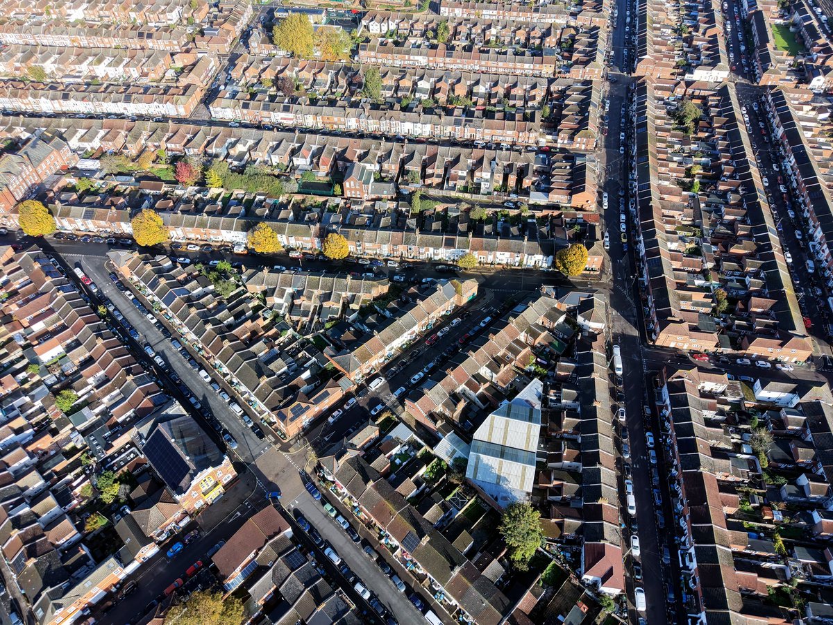 Professional building surveyor from National Home Surveyors inspecting property exterior